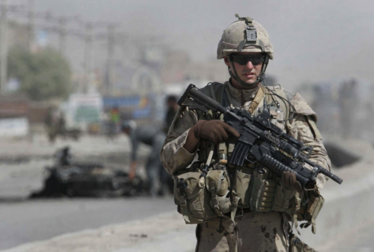 A Canadian soldier with the International Security Assistance Force (ISAF) stands guard at the side of a suicide attack in the city of Kandahar, south of Kabul, Afghanistan on Thursday, Sept. 11, 2008. A suicide bomber attacked a private security company's convoy in Afghanistan's second largest city Thursday, killing two civilians and wounding four other people, a police officer said. (AP Photo/Allauddin Khan)